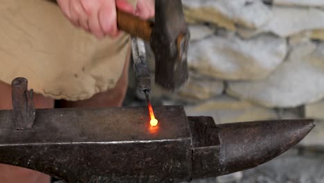 1770s blacksmith shapes - pounts hot metal into a tool