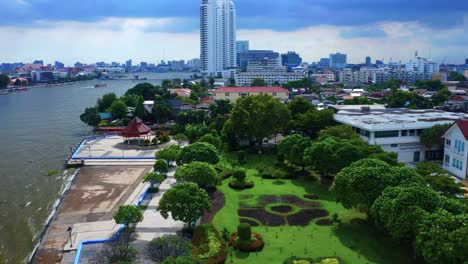 green landscape of an urban park near rivershore of chao phraya river in bangkok, thailand