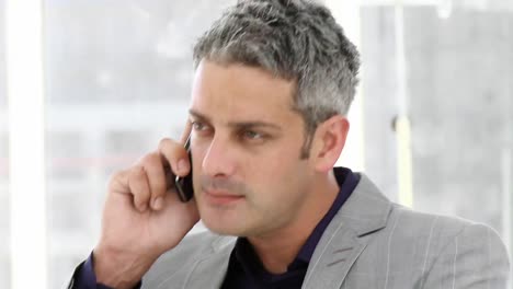 Mature-businessman-talking-on-phone