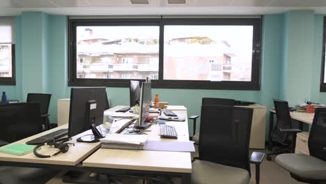 interior of unorganized creative workspace with computer desks