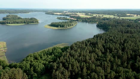 forested islets on the blue waters of the lake and a forest on the shore