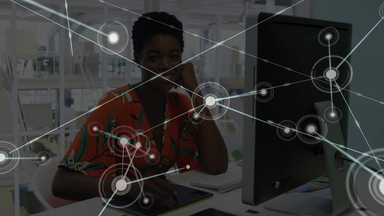 Designer sketching on tablet at desk, nodes appearing expanding across screen over her showing data