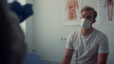 patient listening doctor appointment in hospital close up. medic noting data.