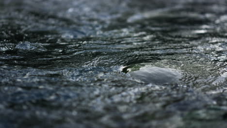 mountain river water surface in slow motion. stream making waves in river