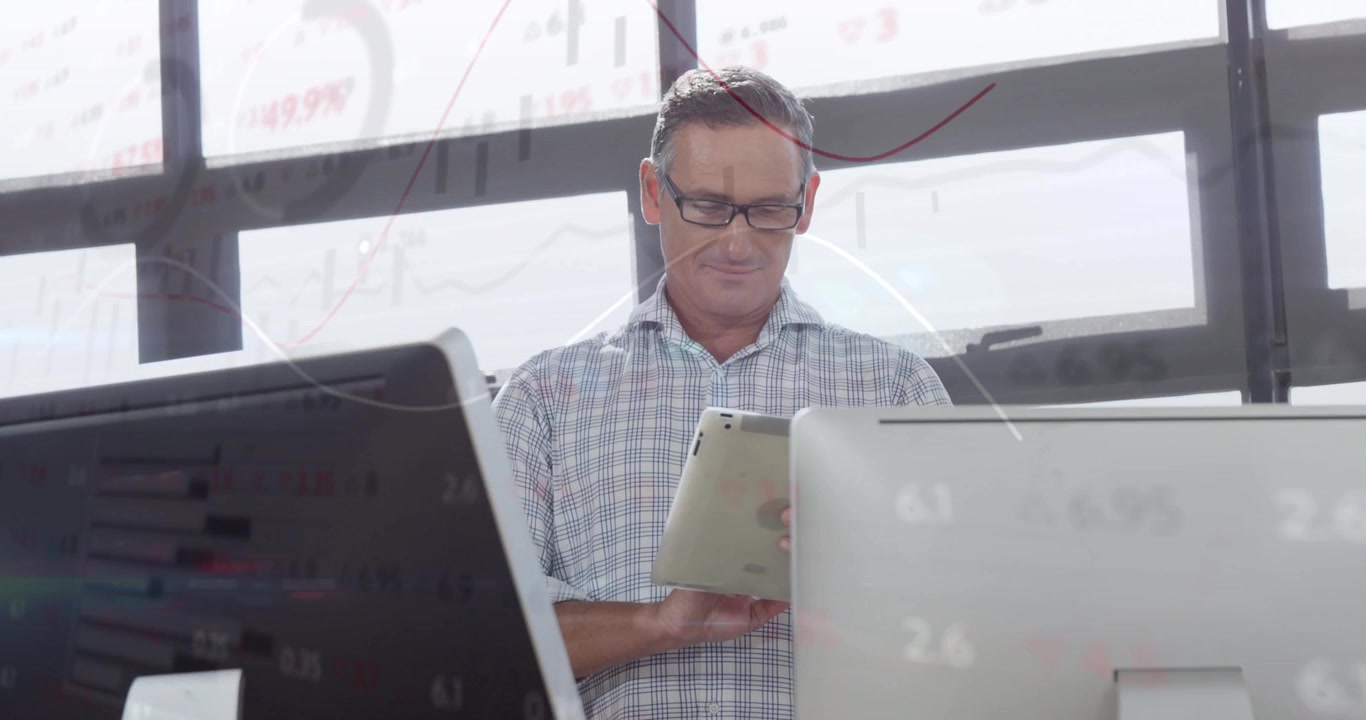 Financial analyst scrolling tablet and viewing red line charts while reviewing market trends