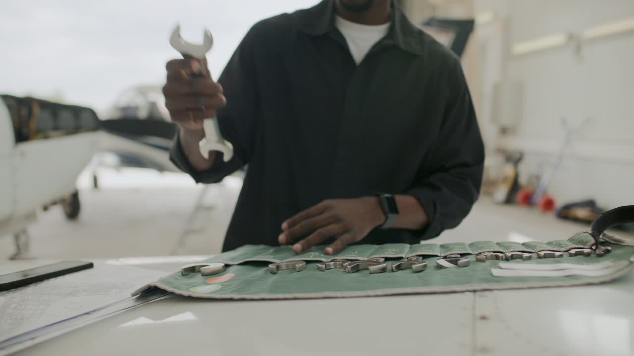 Mechanic Selecting Wrench from Tool Roll for Aircraft Maintenance