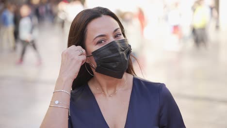 smiling woman outdoors wearing mask