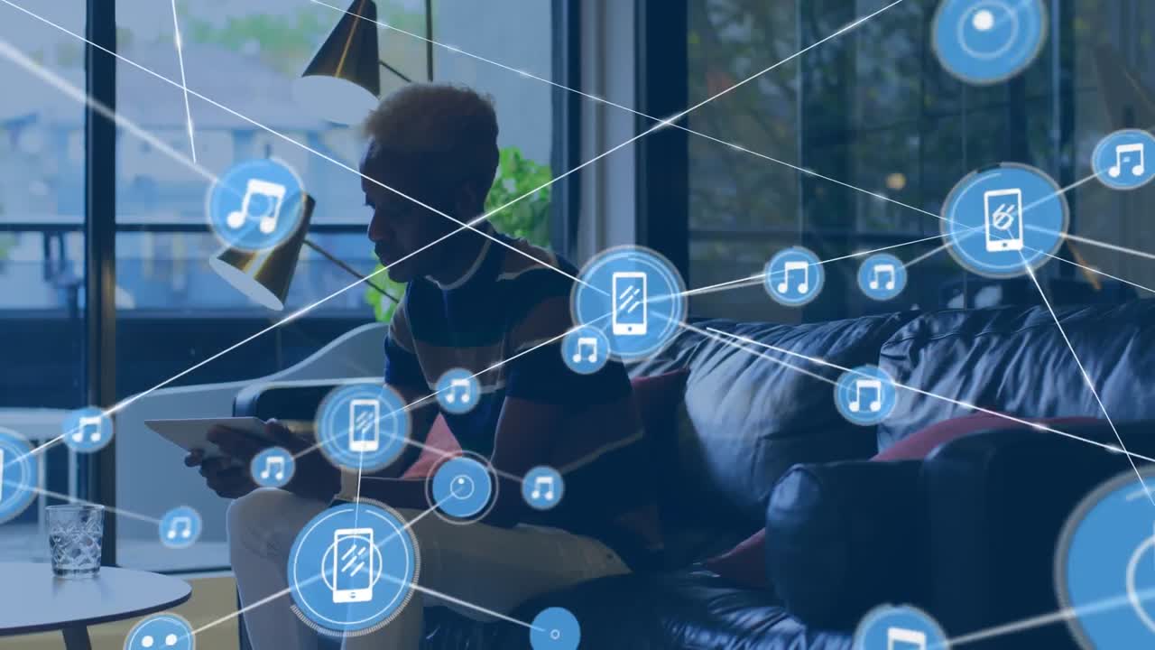 Animation of connected icons over african american man drinking water and using digital tablet