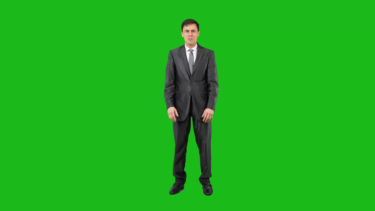 Man in Suit Shivering and Rubbing Hands on Green Screen