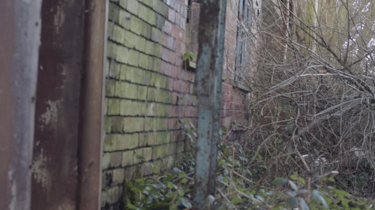 View of derelict abandoned brick building with smashed windows