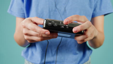 person holding a vintage cassette player