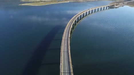 drone shot over a bridge at a lake near kozani in greece