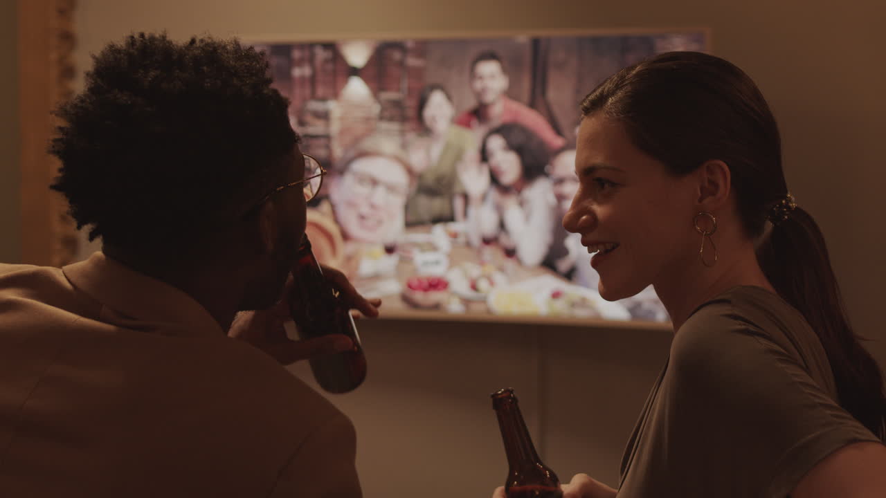 Multiethnic Couple Flirting during Online Celebration Party