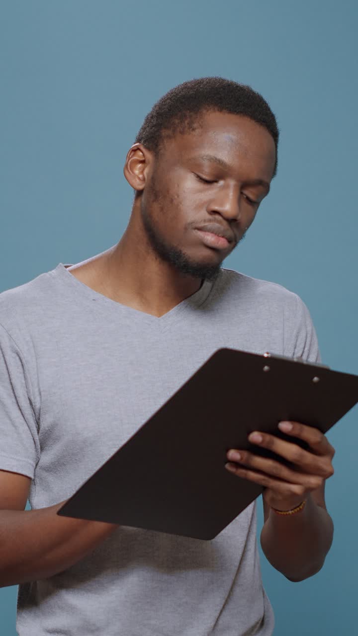 Man writing on a clipboard