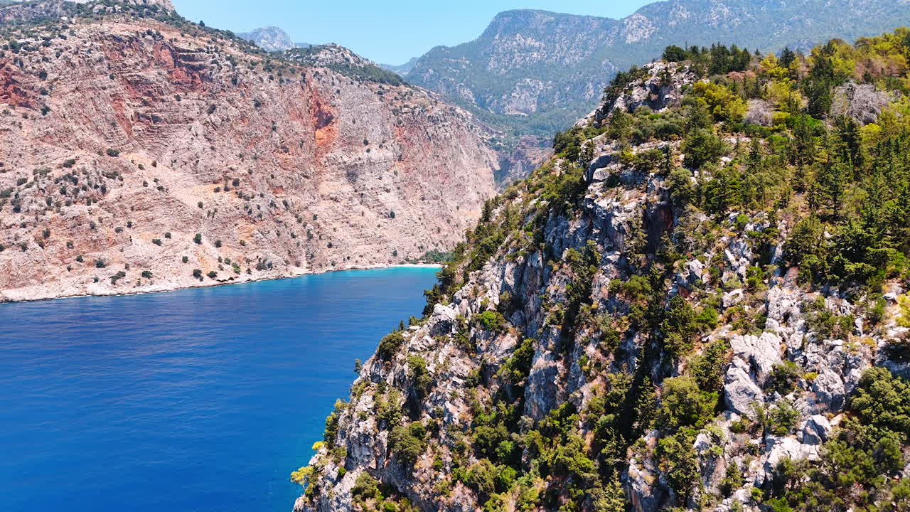 Stunning rocks with scarce greenery. Amazing azure waterscape among the mountains. Aerial view