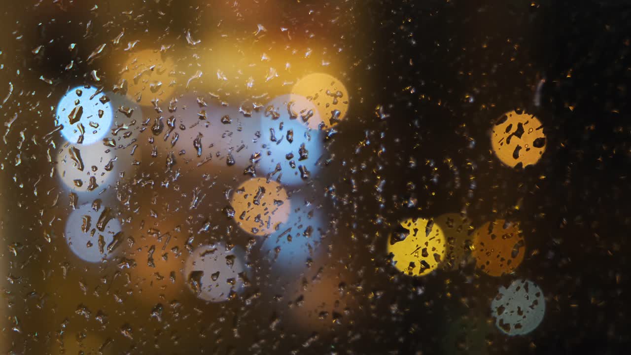 비가 오는 밤 도시의 불빛이 창문을 통해