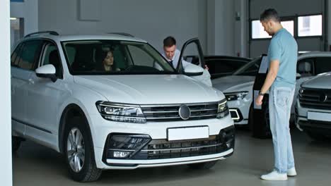 customer looking at a car in a dealership