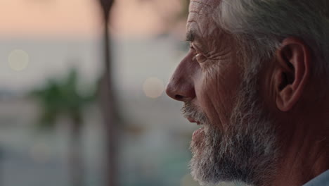 close-up-mature-man-on-vacation-looking-at-beautiful-ocean-at-sunset-contemplating-successful-retirement-lifestyle-planning-ahead-enjoying-relaxing-holiday