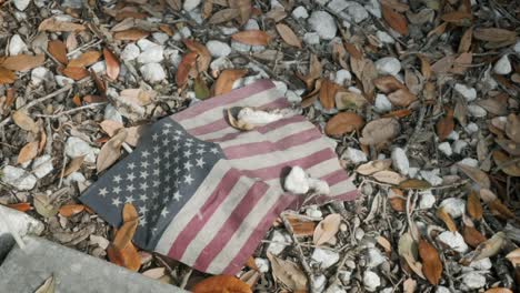 grungy american flag on the ground symbolic of devolving american value system