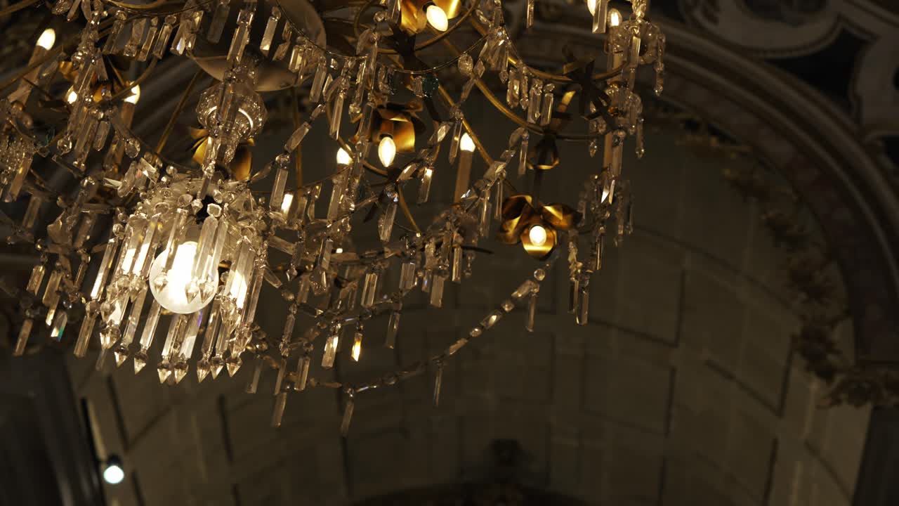 Close up of illuminated vintage chandelier inside classic building