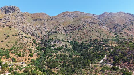 arid mountain landscape with a winding road on a hot summer day in crete