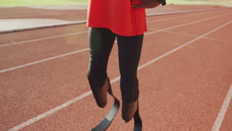 disabled mixed race man with prosthetic legs focusing before a race