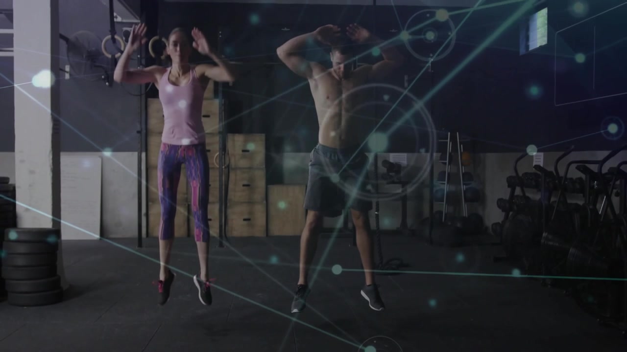 Man and woman starting burpee from push-up at gym for intense fitness with digital overlay graphics