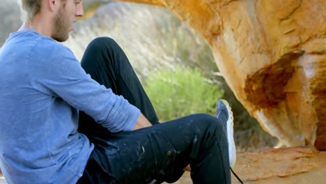 male hiker wearing his shoes 4k