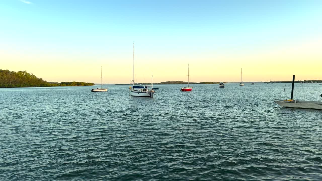 Sunrise view of boats on the river in the regional town of Karuah, New South Wales, Australia.