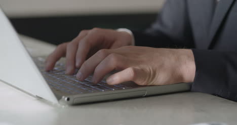 man typing on computer keyboard