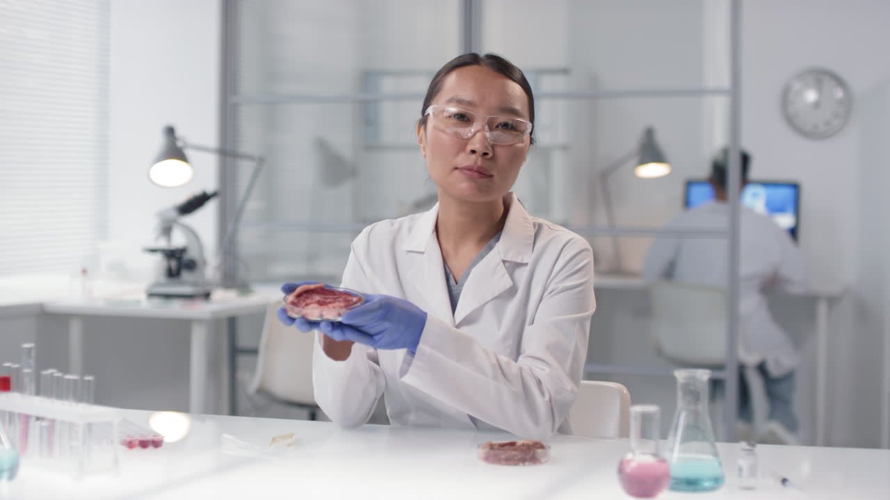Scientist examining a meat sample in a lab