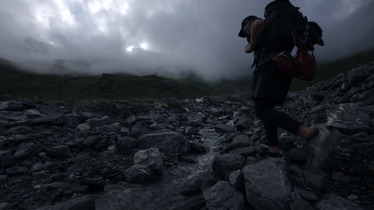 Hiking through a mountainous terrain on a cloudy day