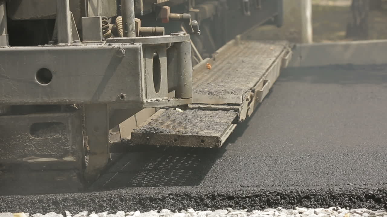 Tracked Paver At Asphalt. Tracked paver at asphalt pavement works for road repairing