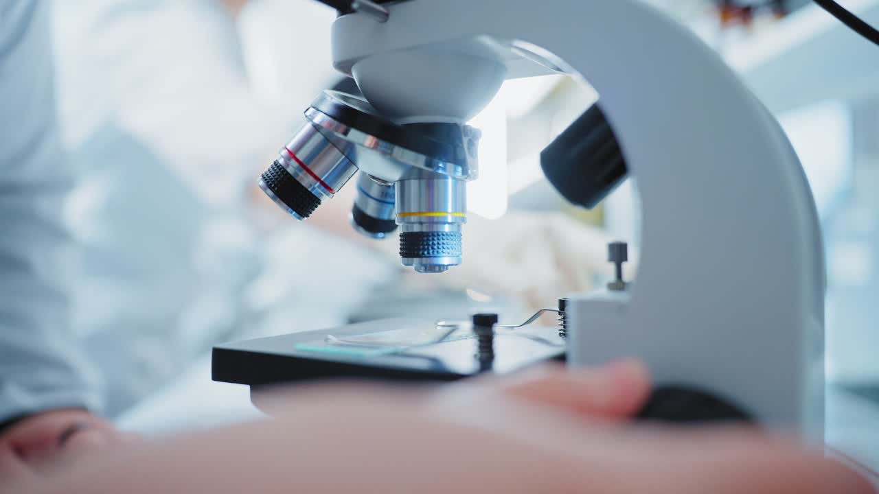 Scientist using a microscope in a laboratory