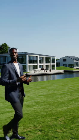 man showcasing luxury property with a waterfront view