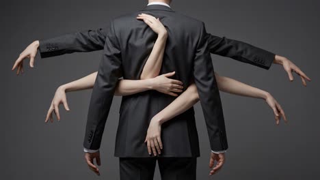 a captivating visual of a man in a suit, surrounded by multiple hands, representing themes of ambition, connection, and complexity in human relationships