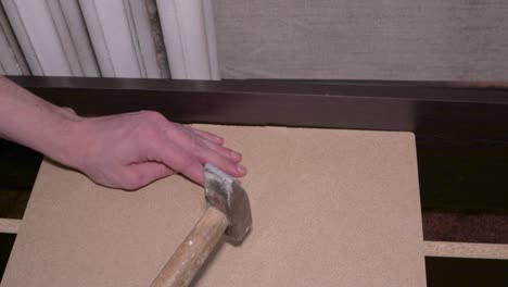 carpenter assembling furniture hit nails hammer professional master