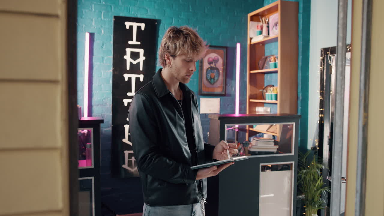 Tattoo Artist Using Tablet in Tattoo Shop