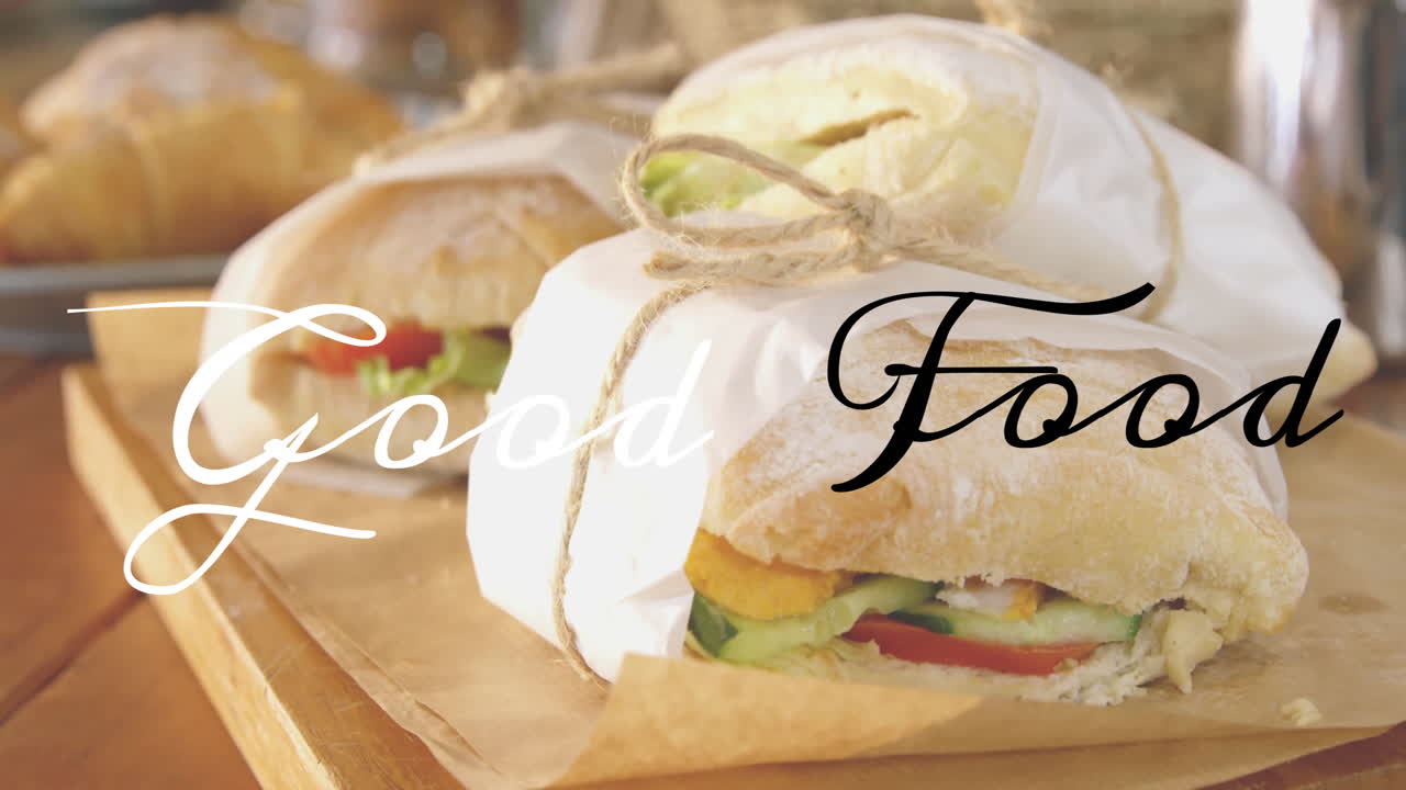 Sandwiches wrapped in paper with Good Food text animation over them
