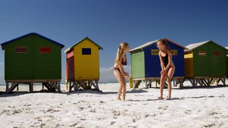 Siblings-jumping-on-beach-4k-