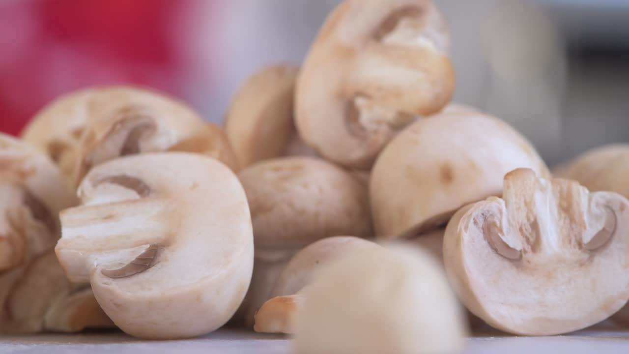 Close on Chopped Mushrooms Poured Onto Chopping Board