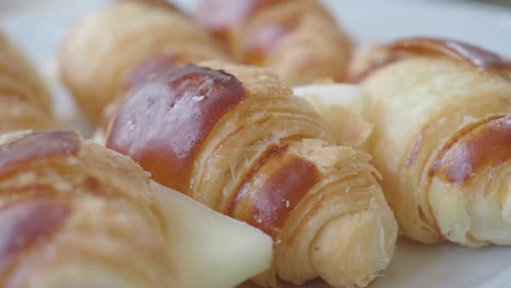 hand picking a cheese croissant