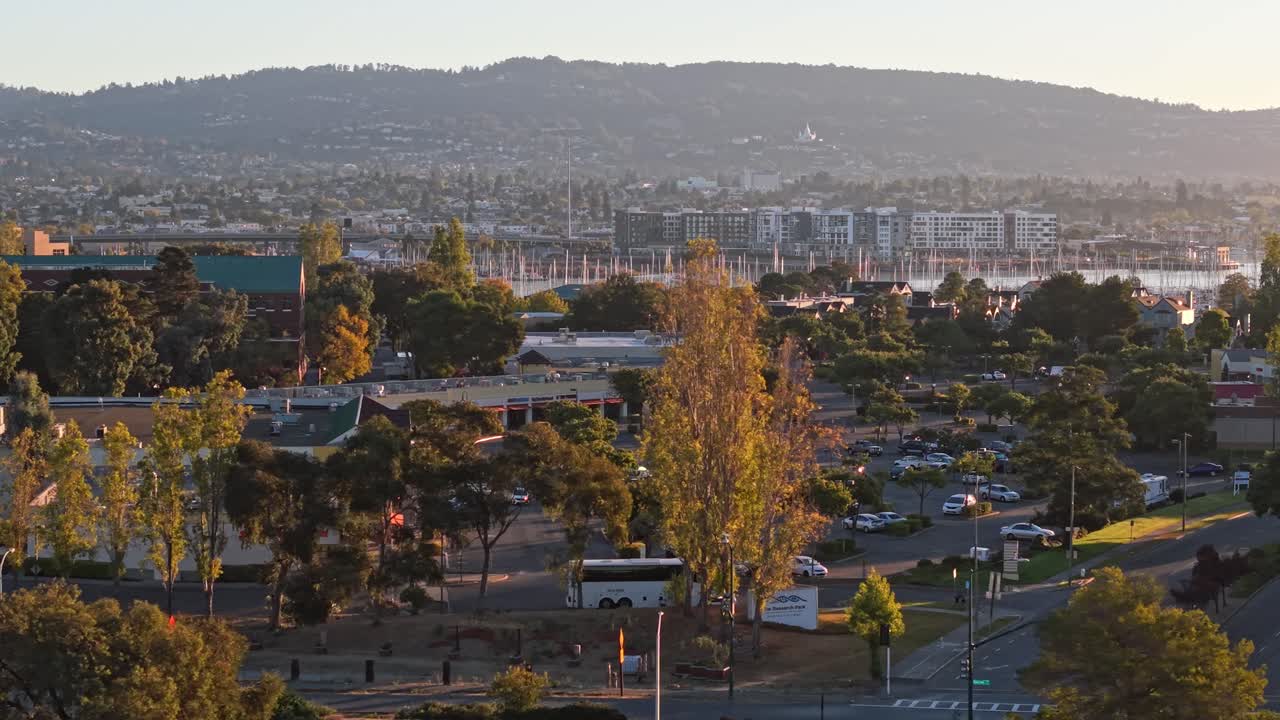 A left to right panning view from a drone of the Marina Village neighborhood in Alameda California. Downtown Oakland is viewed in the distance