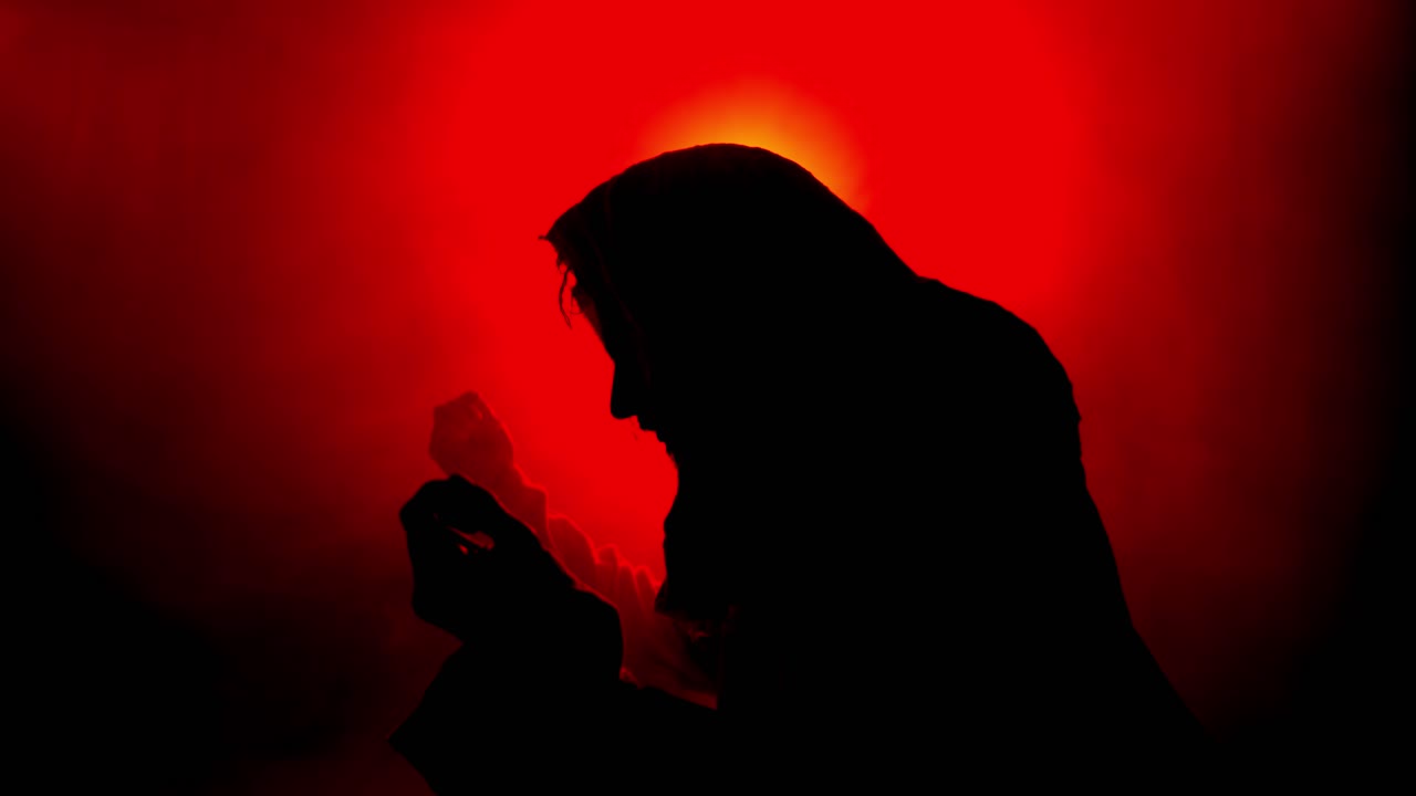 Dramatic, stylistic, Jesus Christ in praying, worshipping in red glowing light for Christianity, Easter visual, bible scene or temptation, prayer, worship visual.