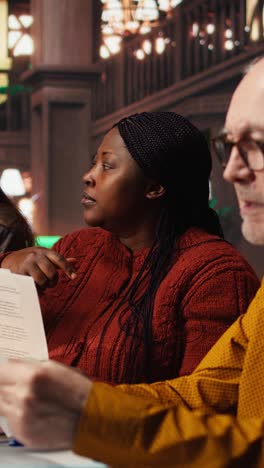 vertical video multiethnic team of actors rehearsing their lines in the theatre library,