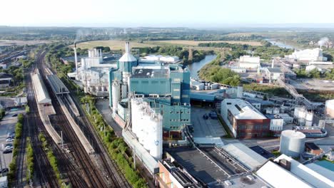 Industrial-chemical-manufacturing-factory-next-to-Warrington-Bank-Quay-train-tracks-aerial-right-orbit-shot