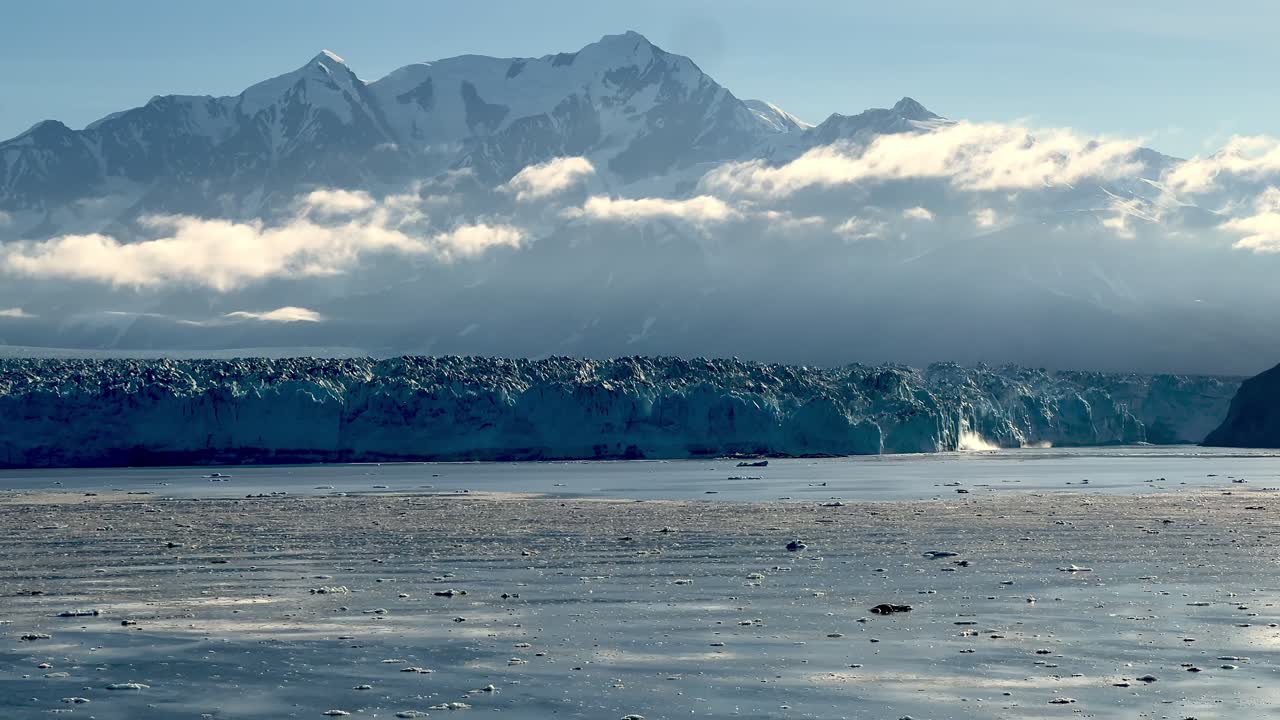 hubbard glacier with snow capped mountains in background