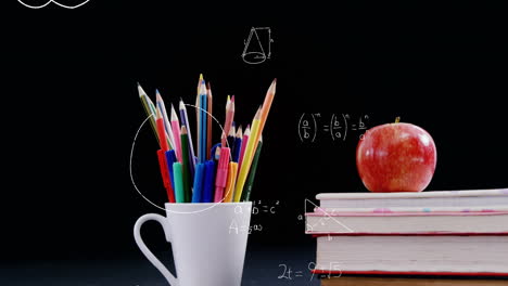 mathematical equations floating against apple on stack of books and pencil stand