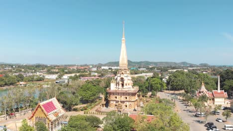 Showcase-view-of-Wat-Chaiyataram-biggest-Buddhist-temple-in-Phuket,-Thailand---Aerial-wide-Fly-over-shot