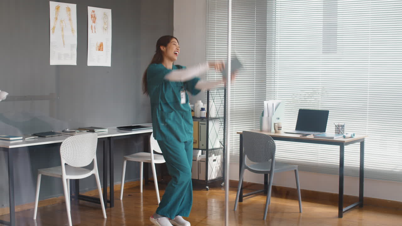 Vertical of Happy Medical Worker Dancing in Clinic
